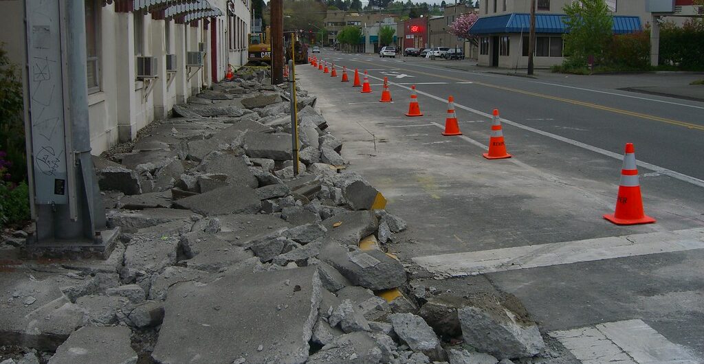 a stone bridge over a river surrounded by mountains